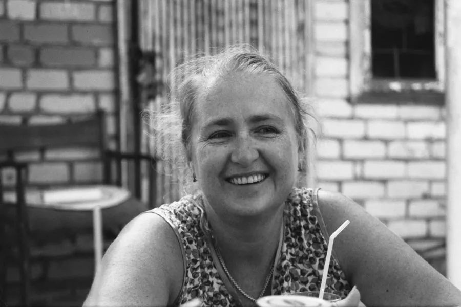 A woman laughing outdoors